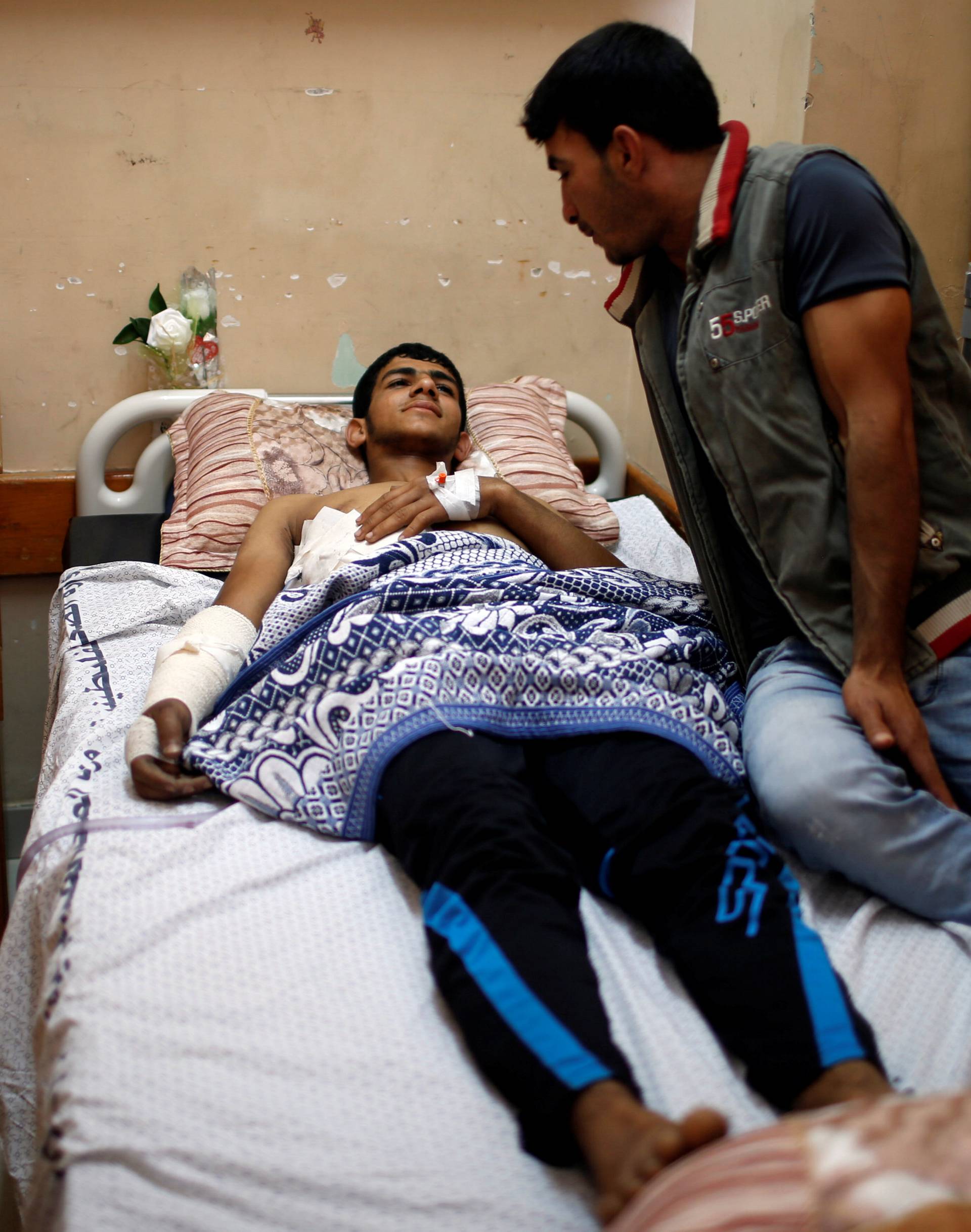 Injured Palestinian lies on a bed at a hospital in Gaza City