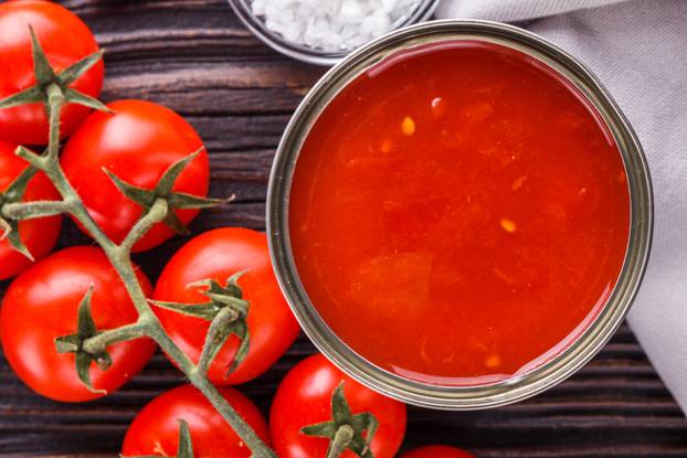 juicy canned tomatoes on wooden rustic background