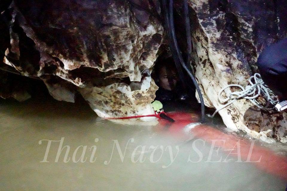 Rescue personnel work at the Tham Luang cave complex, as members of an under-16 soccer team and their coach have been found alive according to local media, in the northern province of Chiang Rai