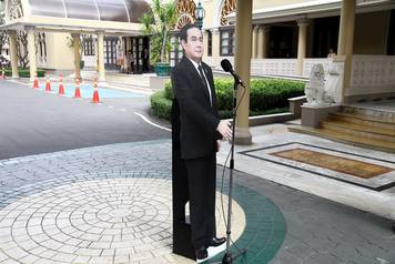 A cardboard cut-out of Thailand's Prime Minster Prayuth Chan-ocha is seen next to a microphone after a news conference at government house in Bangkok