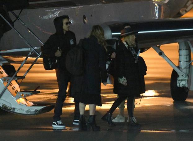 EXCLUSIVE: Madonna arrives with her adopted children and possible boyfriend 25 year-old dancer Ahlamalik Williamson on a private jet in Miami
