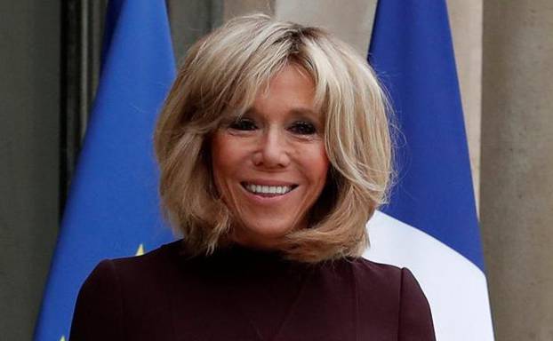 Brigitte Macron, wife of the French President, waits to welcome guests at the Elysee Palace in Paris