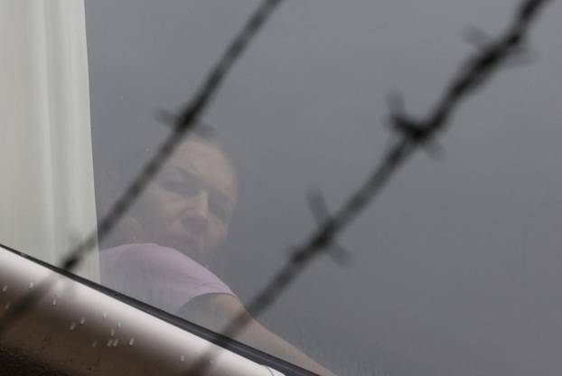 Tennis player Renata Voracova looks out a window from the Park Hotel in Melbourne