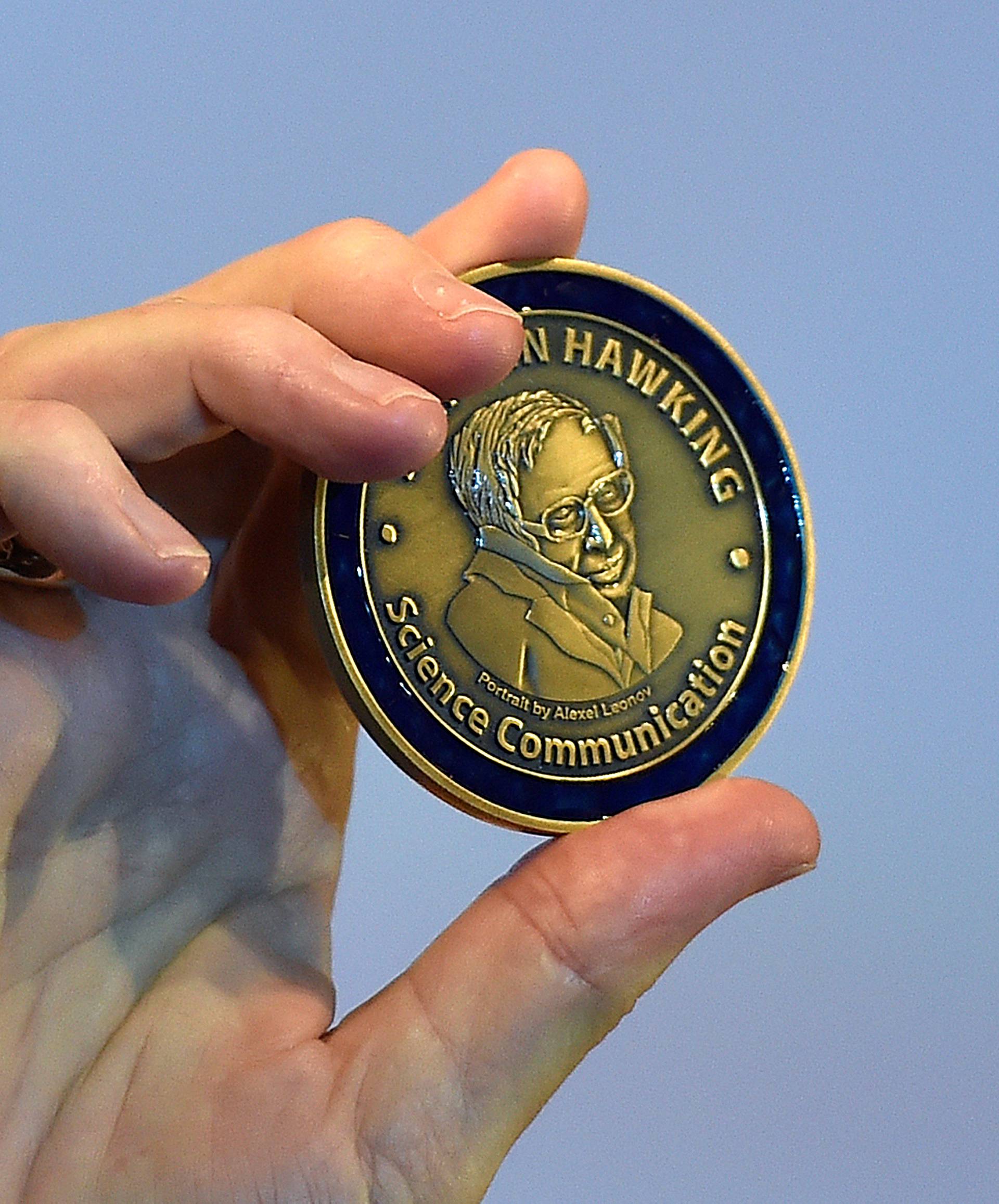 FILE PHOTO: British musician and astrophysicist May holds a medal as he attends a launch event for a new award for science communication, called the Stephen Hawking Medal for Science Communication, in London in Britain
