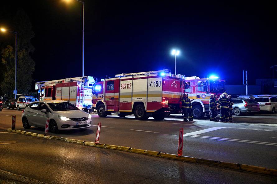 First responders attend the scene of a collision between two trains in the town of Pezinok