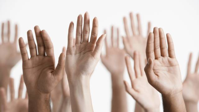 Closeup,Of,Multiethnic,Men,And,Women,Raising,Hands,Against,White
