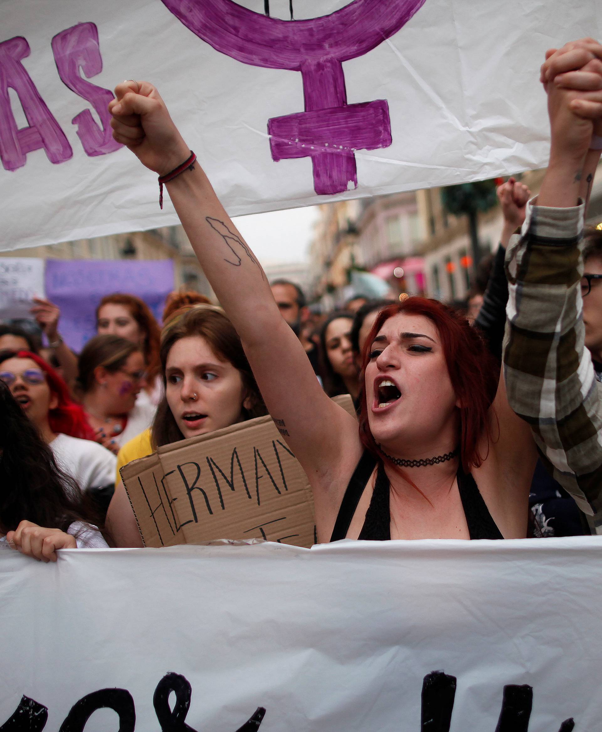 People shout slogans during a protest after a Spanish court condemned five men accused of the group rape of an 18-year-old woman, in Malaga