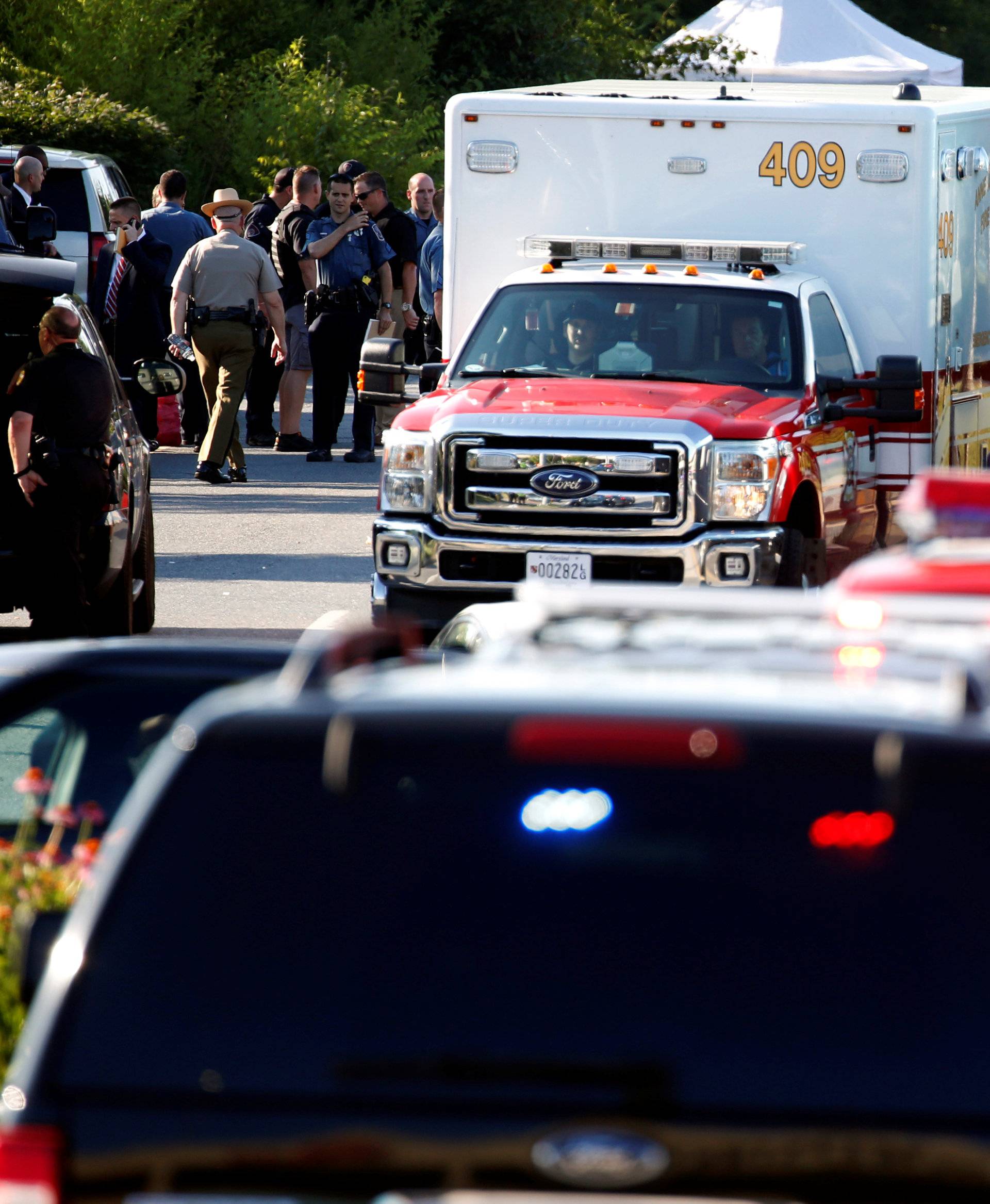 Emergency response vehicles drive near a shooting scene at the Capital Gazette newspaper in Annapolis