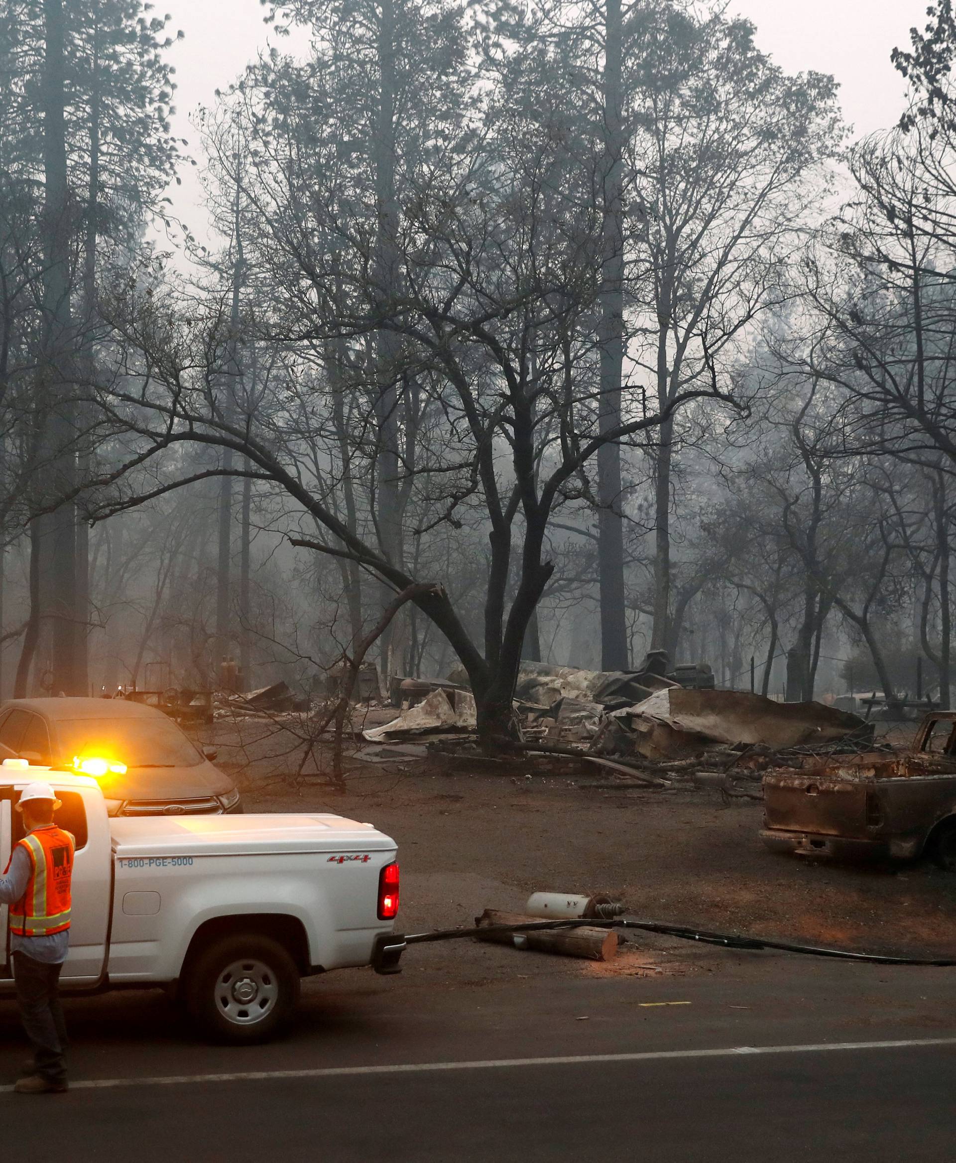 FILE PHOTO: Employees of Pacific Gas & Electric work in the aftermath of the Camp Fire in Paradise
