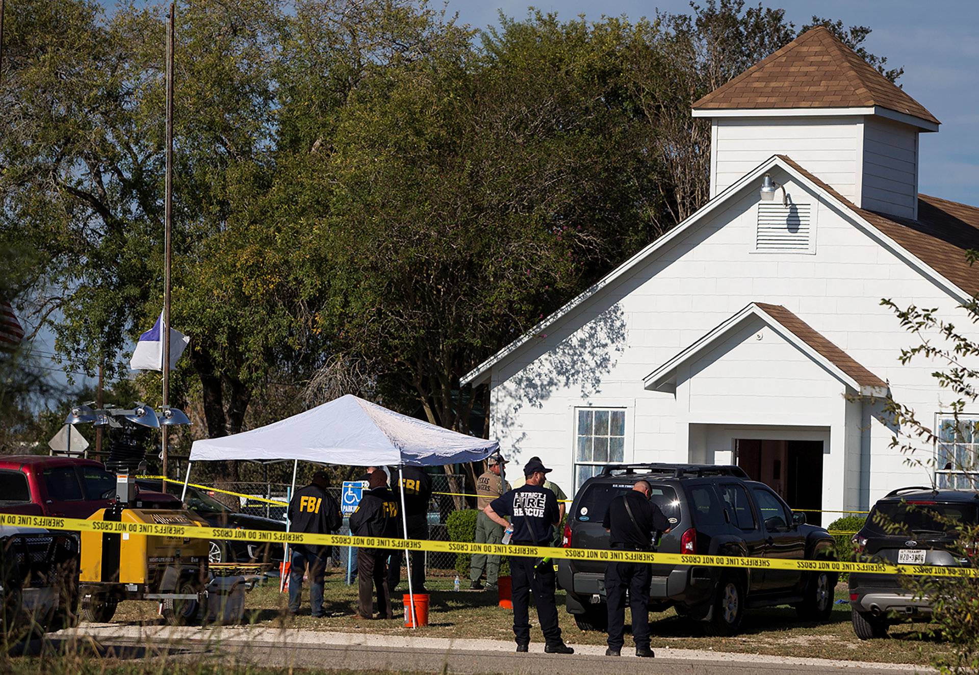 Law enforcement officials investigate a mass shooting at the First Baptist Church in Sutherland Springs