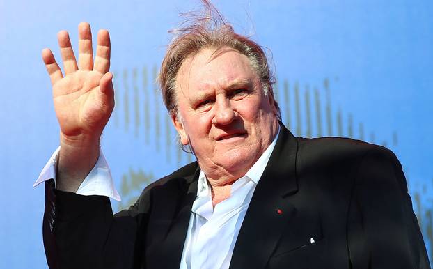 FILE PHOTO: Gerard Depardieu waves as he arrives during a red carpet event for the movie "Novecento- Atto Primo" at the 74th Venice Film Festival in Venice