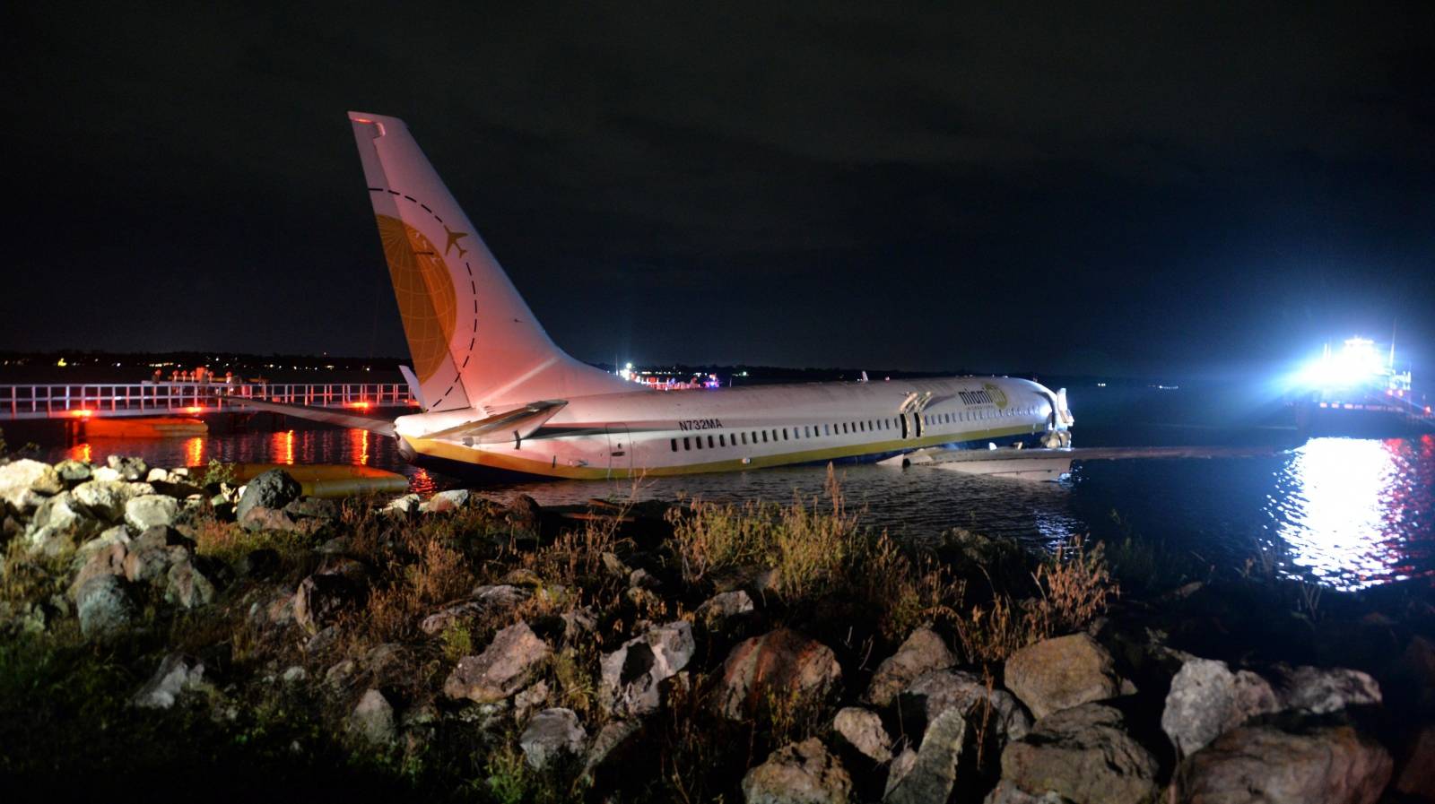 Boeing 737 aircraft sits in shallow water of the St Johns River after it slid off the runway at Naval Air Station, Jacksonville, Florida