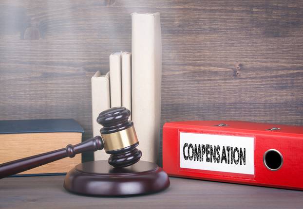 Compensation.,Wooden,Gavel,And,Books,In,Background.,Law,And,Justice