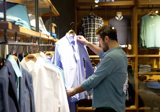 Portrait,Of,A,Young,Man,Shopping,For,Clothes,At,Store