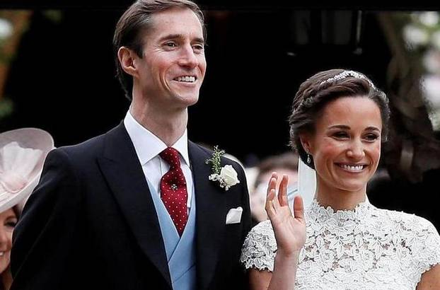 FILE PHOTO: Pippa Middleton and James Matthews pose for photographs after their wedding at St Mark