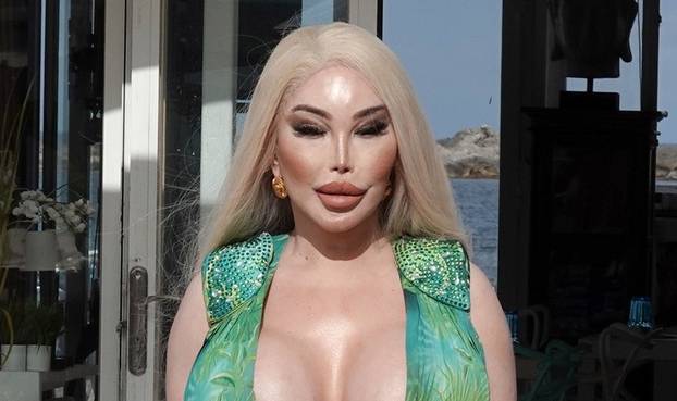 Former Human Ken doll Jessica Alves is pictured showing off her surgically enhanced cleavage while enjoying lunch in Ibiza.