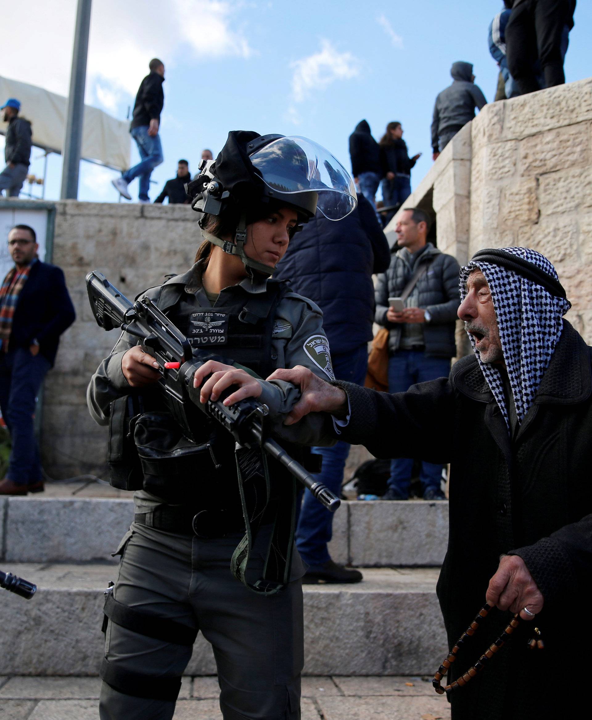 A Palestinian man argues with an Israeli border policewoman during a protest following U.S. President Donald Trump's announcement that he has recognized Jerusalem as Israel's capital, near Damascus Gate in Jerusalem's Old City