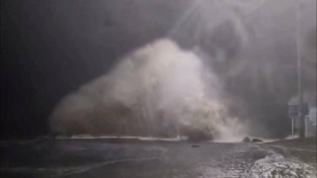 A wave crashes into land as tides rise due to Cyclone Gabrielle in Waiwera, Auckland