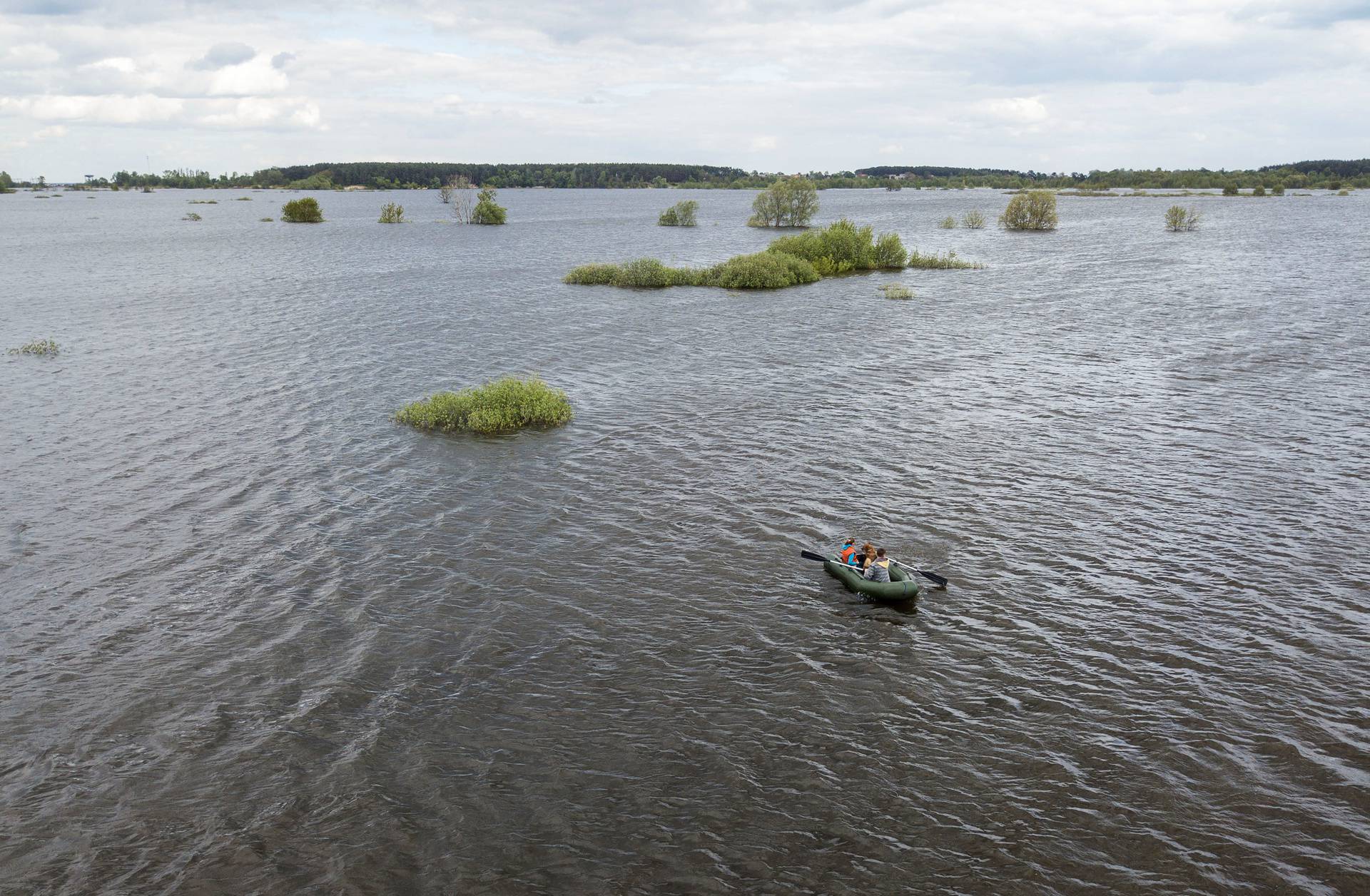 Local residents are seen on a boat at a flooded area after Ukrainian military forces opened a dam to flood an residencial area in order to stop advance of Russian forces to arrive to the capital city of Kyiv, in Demydiv, Ukraine