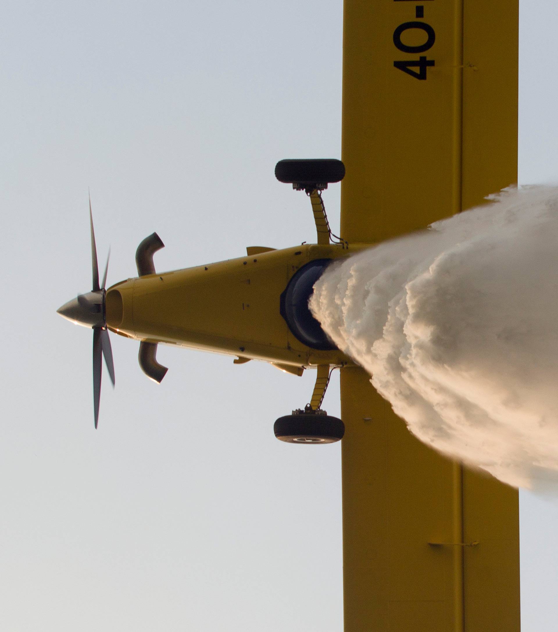 A firefighting plane drops water to extinguish a forest fire at Lustica peninsula near Tivat