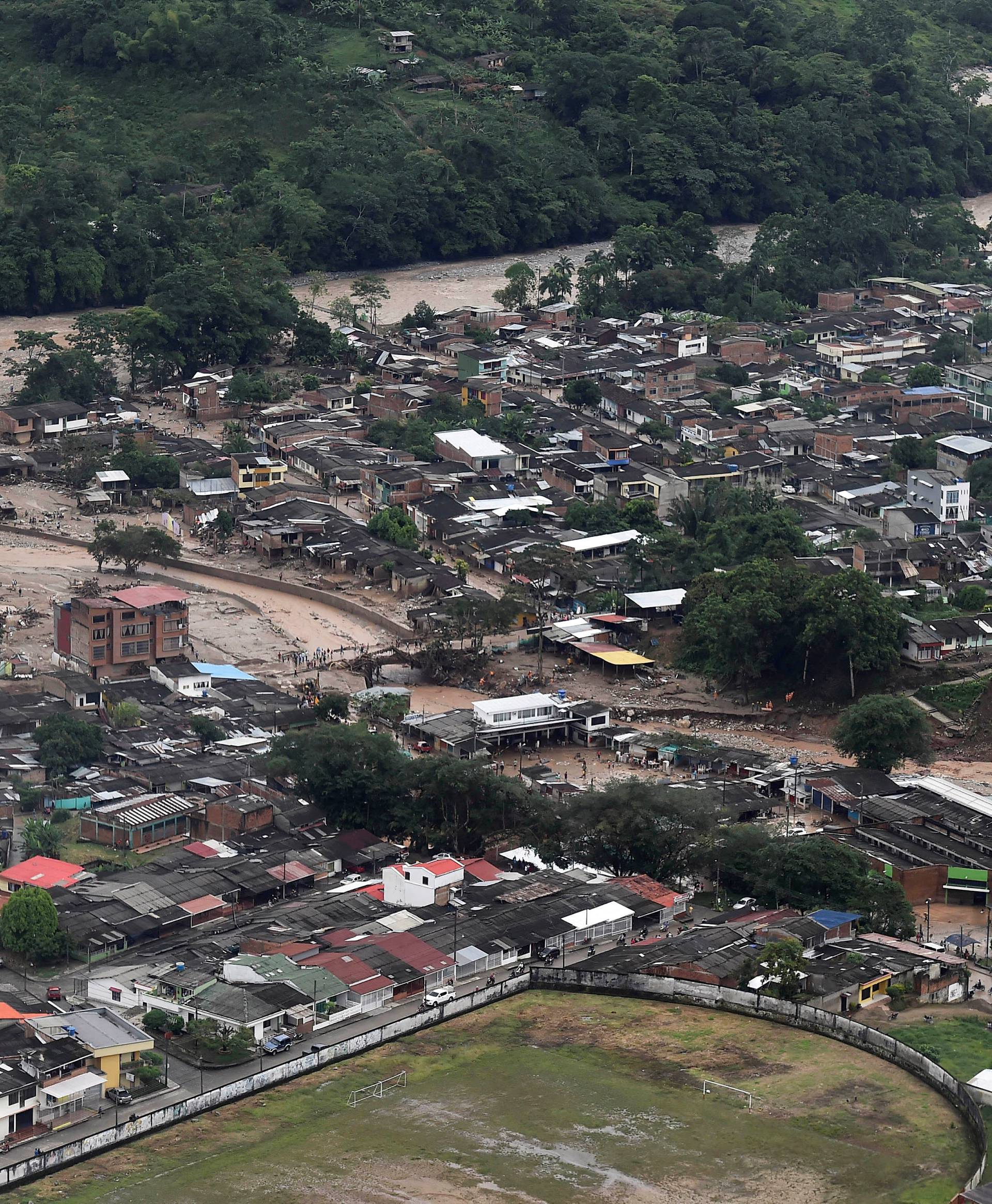 An aerial view shows a flooded area after heavy rains caused several rivers to overflow, pushing sediment and rocks into buildings and roads in Mocoa