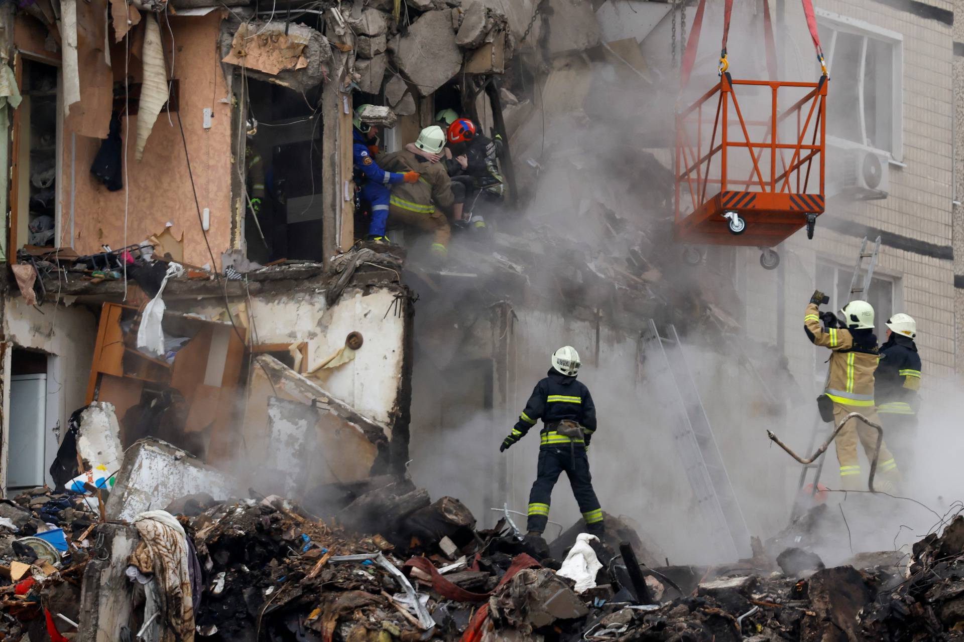 Aftermath of Dnipro apartment block destruction following missile strike