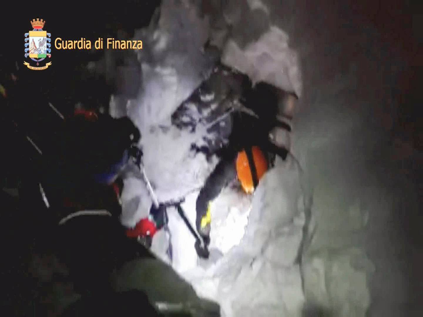 A photo taken from a video shows a rescuer entering the Hotel Rigopiano in Farindola, central Italy, hit by an avalanche