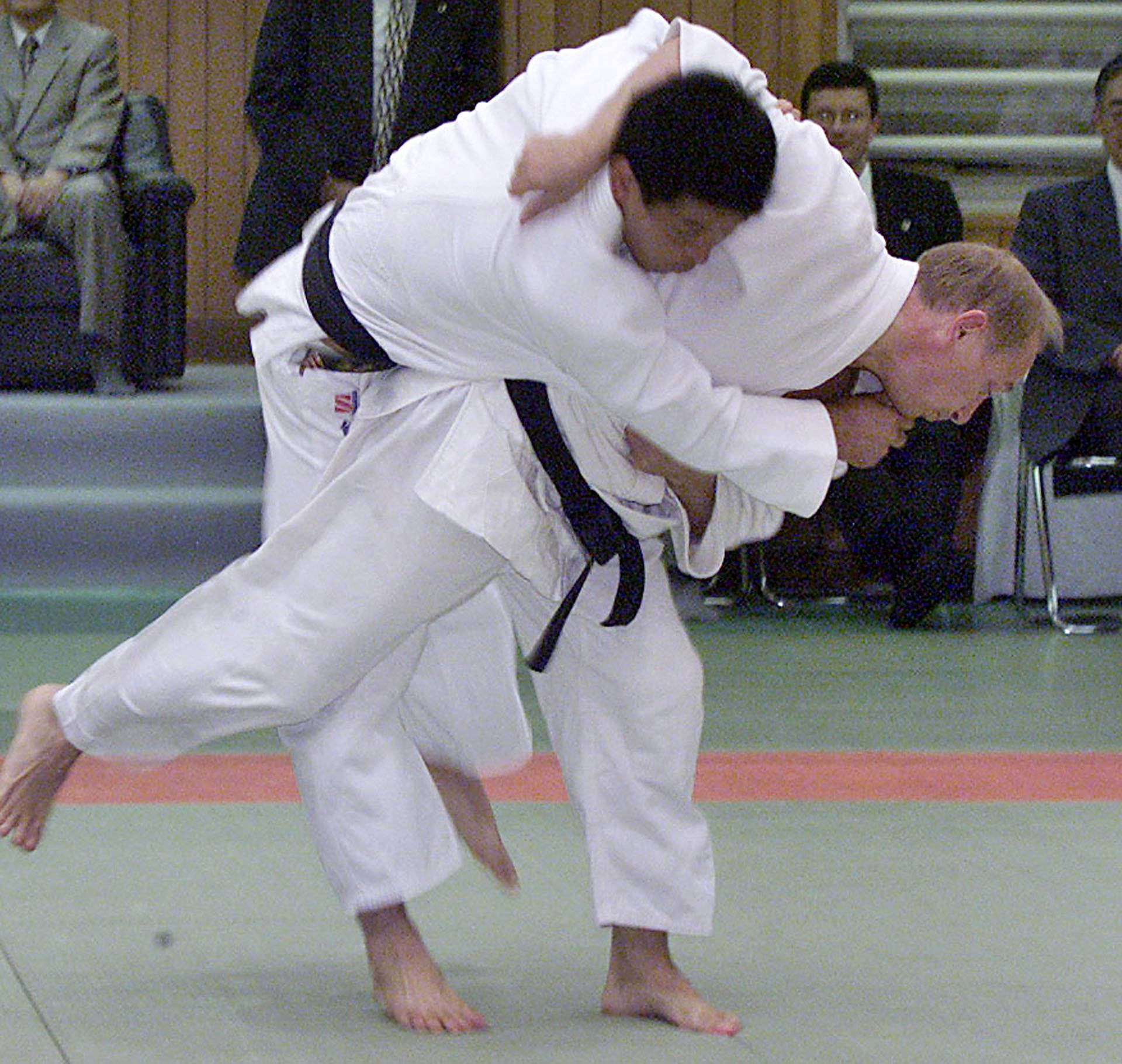 FILE PHOTO: Russian President Vladimir Putin (R) throws a Japanese judo expert during a judo demonstration at the Kodokan in Tokyo