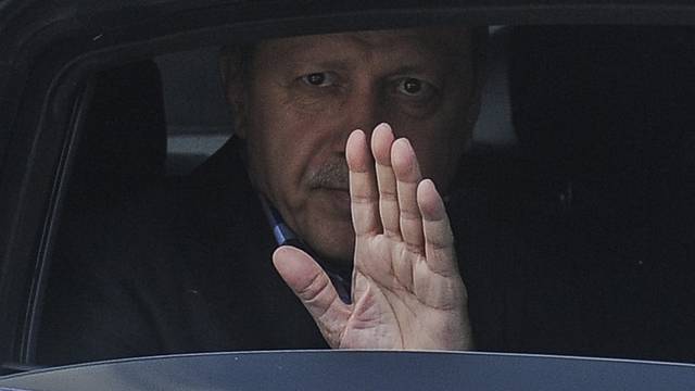 Turkish President Erdogan waves from his car after leaving his residence in Istanbul
