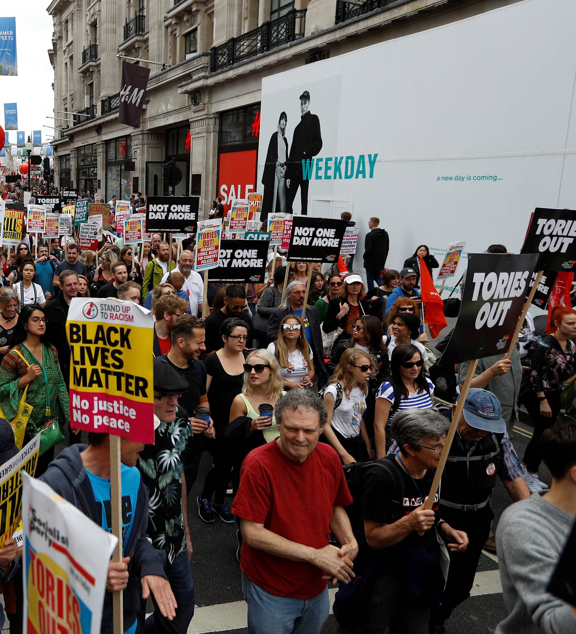 Demonstrators walk towards Parliament Square on an anti-austerity rally and march organised by campaigners Peoples' Assembly, in central London