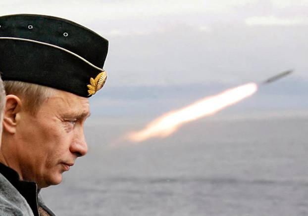 FILE PHOTO: Russian President Putin watches the launch of a missile during naval exercises