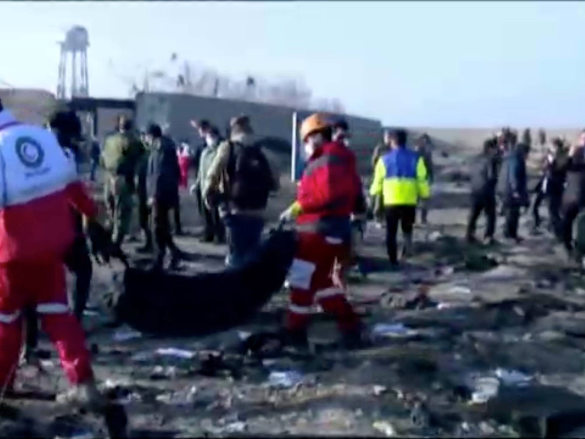 Emergency workers work near the wreckage of Ukraine International Airlines flight PS752, a Boeing 737-800 plane that crashed after taking off from Tehran's Imam Khomeini airport