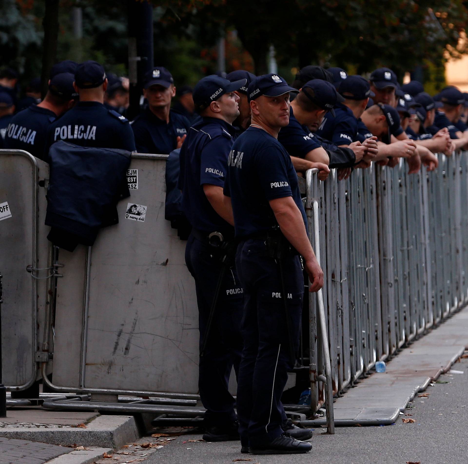 FILE PHOTO: Police stand near barriers as they secure Parliament's area during an anti-government protest in support of free courts outside the Parliament building in Warsaw