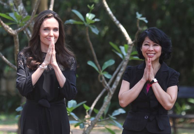 Actress Angelina Jolie and Cambodian-born American human-rights activist and lecturer Loung Ung greet as they arrive for a news conference at hotel in Siem Reap province