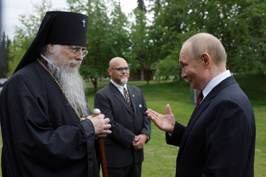 Russian President Vladimir Putin lays flowers at the graves of Soviet soldiers at Fort Richardson National Cemetery near Anchorage