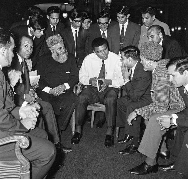  Muhammad Ali (formerly Cassius Clay) speaks to Muslims holding a book called Towards Understanding Islam written by Sayyid Abul Ala Maududi in London
