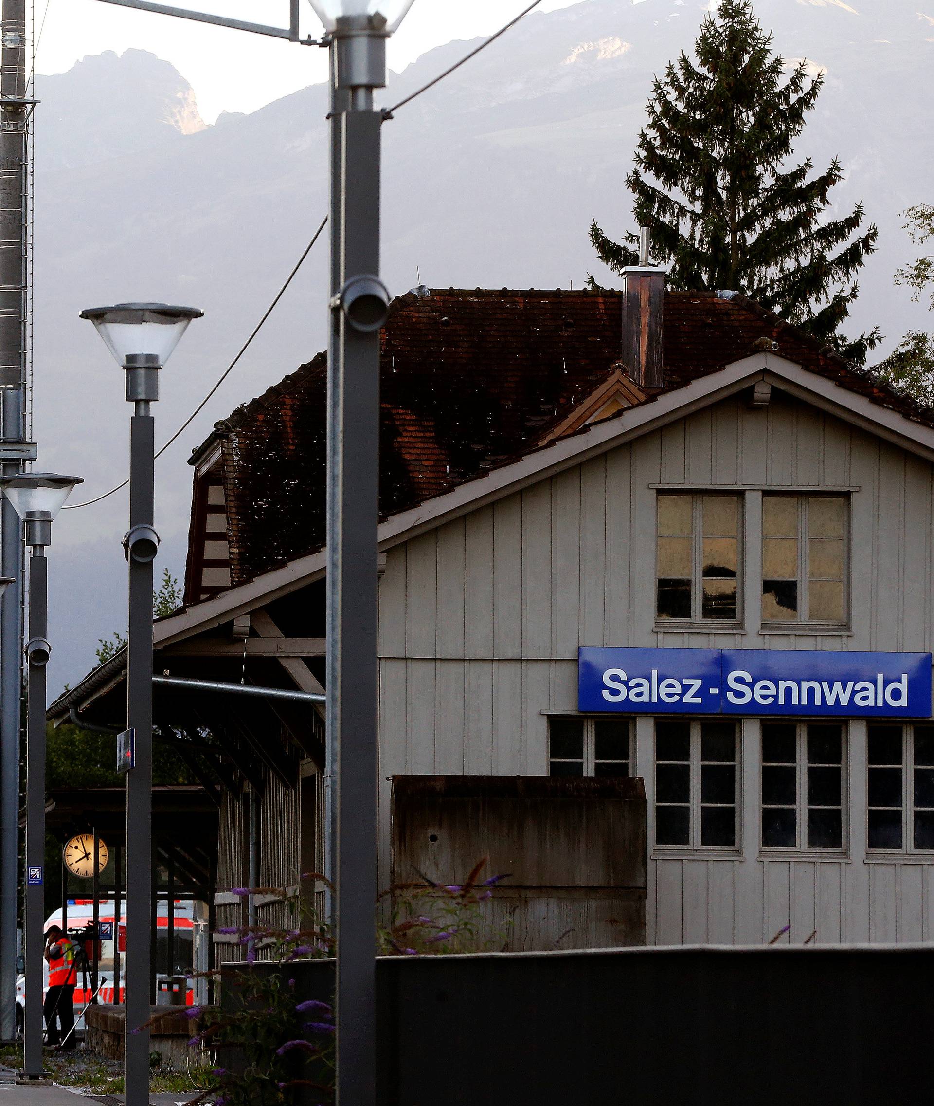 Workers clean a platform after a 27-year-old Swiss man's attack on a Swiss train at the railway station in the town of Salez