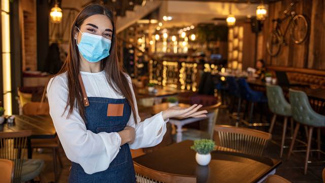 Portrait,Of,Beautiful,Waitress,Wearing,Protective,Face,Mask,While,Holding
