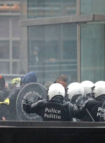 Police officers face off with far-right supporters during a protest against Marrakesh Migration Pact, outside European Commission headquarters, in Brussels
