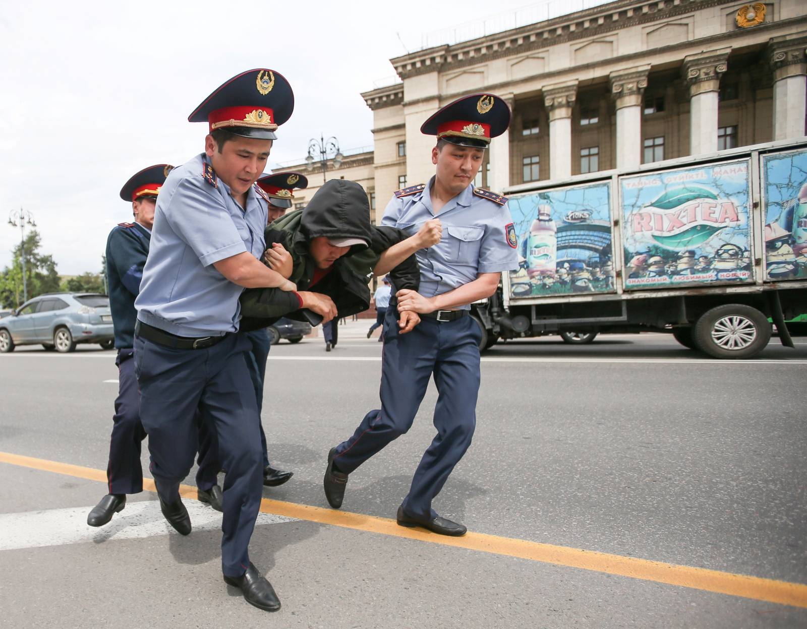Police officers detain an opposition supporter during a protest against presidential election results, in Almaty