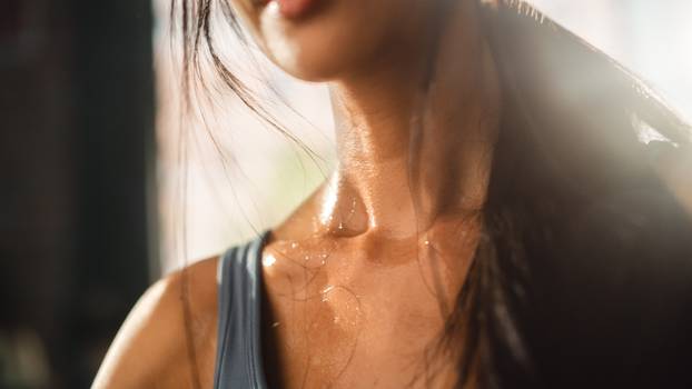 Close up Shot of a Young Adult woman's neck Sweating After Heavy Workout at Home. Successful Empowered Woman Fighting