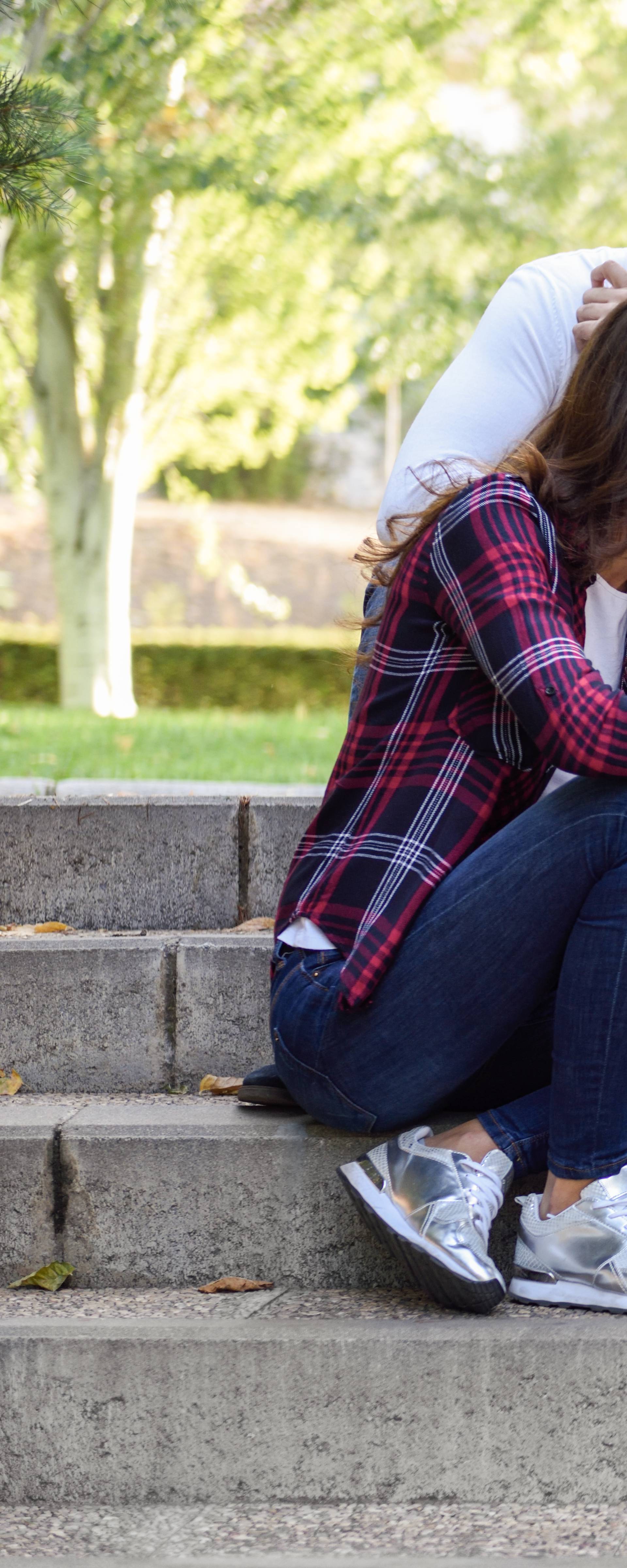 Young people using smartphone and tablet computers outdoors