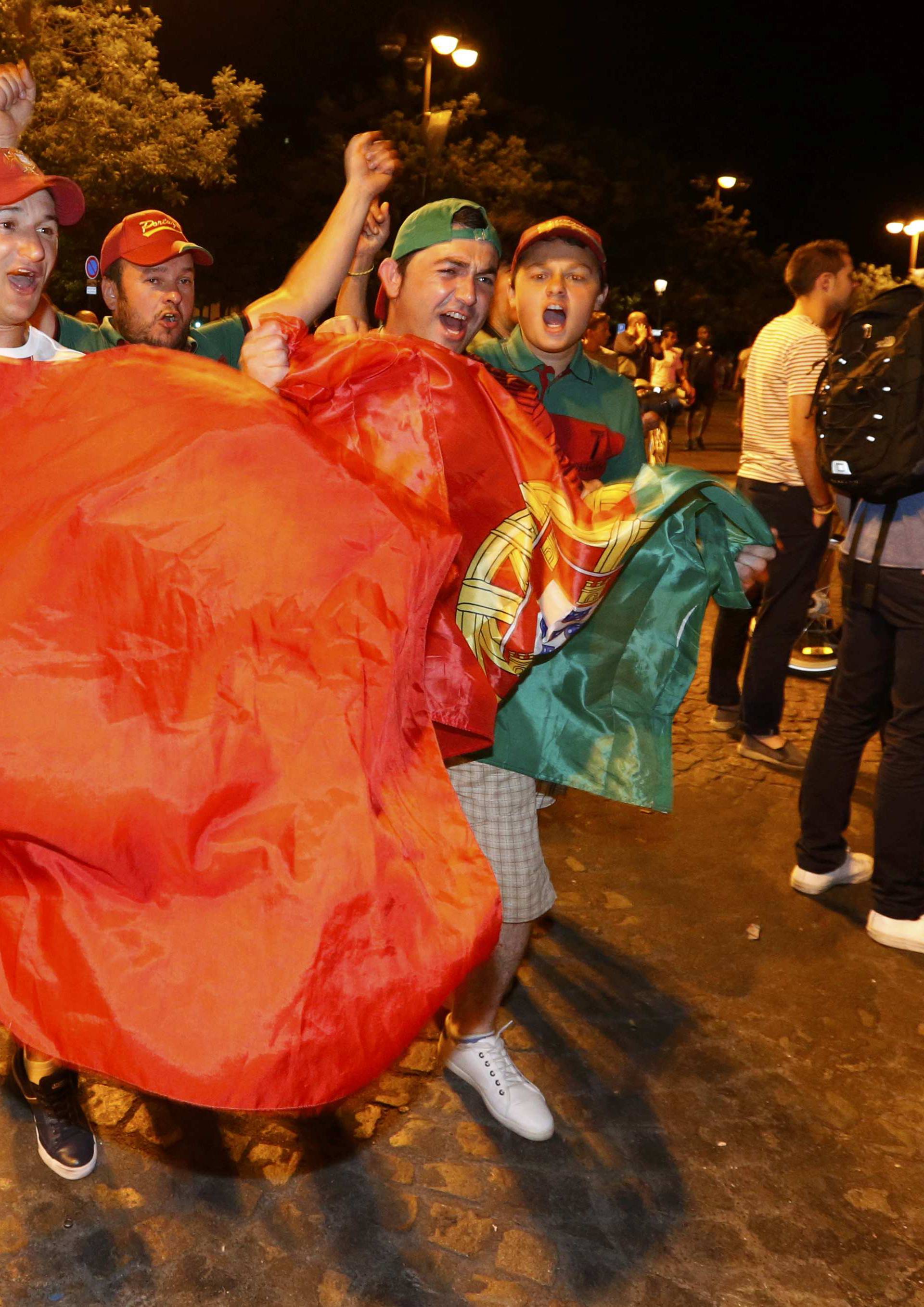 Portugal fans react on the Champs-Elysees after their team won the EURO 2016 final soccer match       
