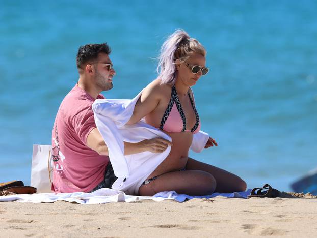 PREMIUM EXCLUSIVE: Britney Spears is seen wearing a pink and black bikini before covering up in a bath robe while on vacation with her boyfriend Sam Asghari