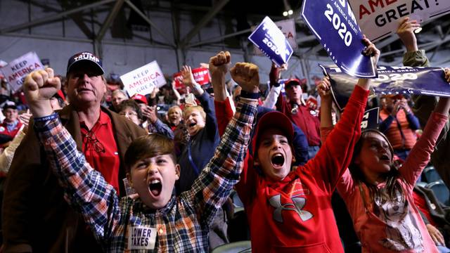 Young supporters cheer as U.S. President Donald Trump speaks during a campaign rally in Tupelo, Mississippi