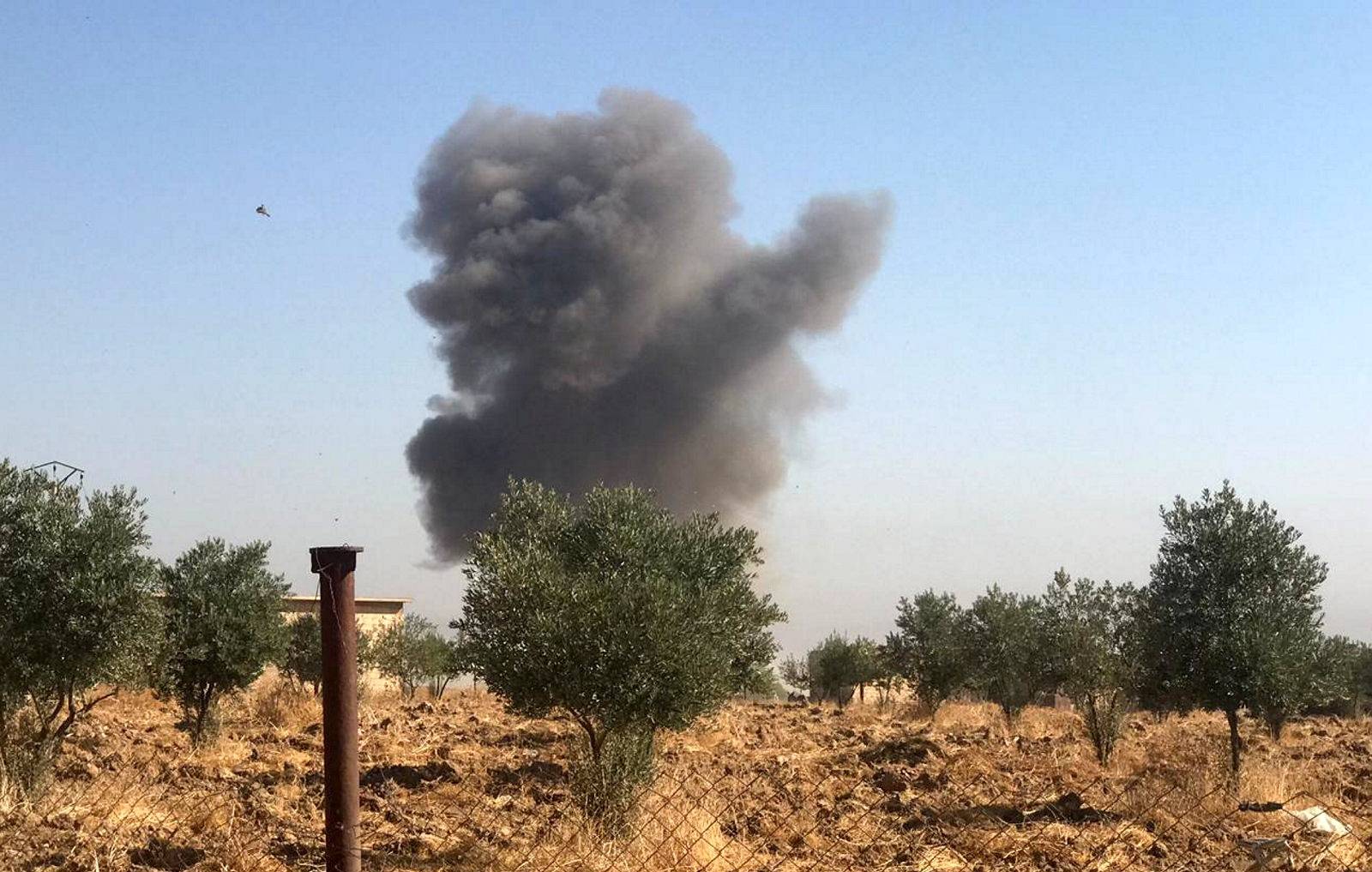 Smoke rises from Tel Arkam village in Ras al Ain countryside