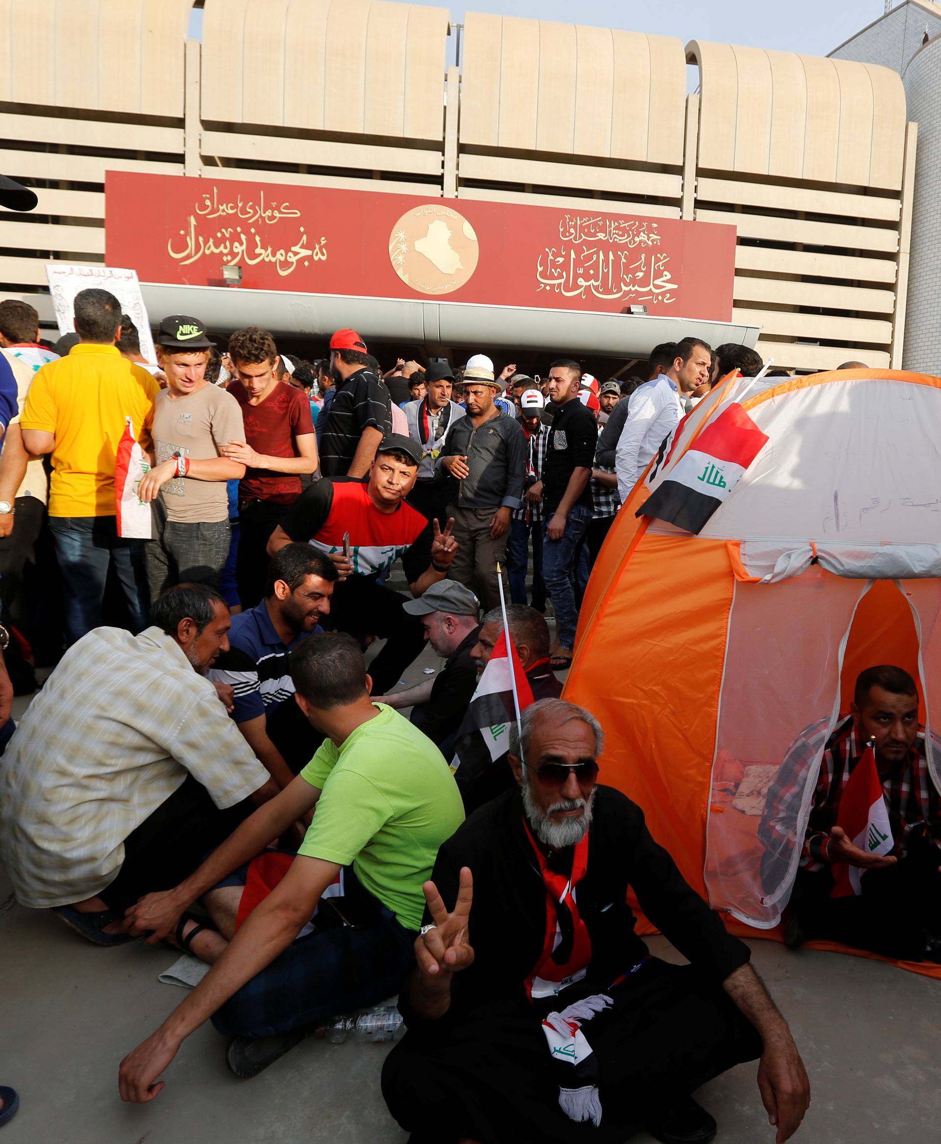 Followers of Iraq's Shi'ite cleric Moqtada al-Sadr are seen in the parliament building as they storm Baghdad's Green Zone after lawmakers failed to convene for a vote on overhauling the government, in Iraq