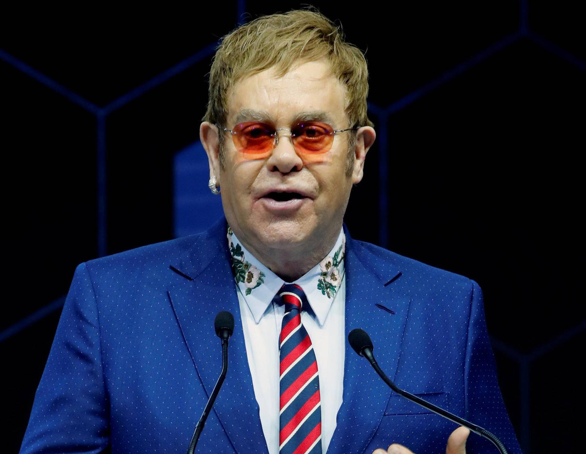 Singer Elton John speaks after receiving a Crystal Award from Hilde Schwab, Chairperson and Co-Founder, Schwab Foundation for Social Entrepreneurship, during the World Economic Forum (WEF) annual meeting in Davos
