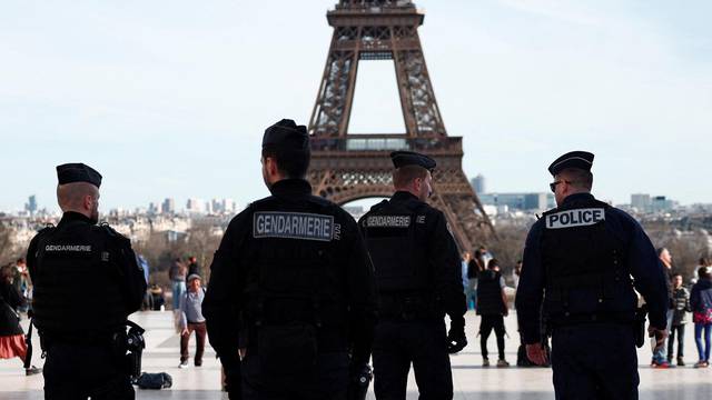 French police and gendarmes patrol near the Eiffel Tower in Paris