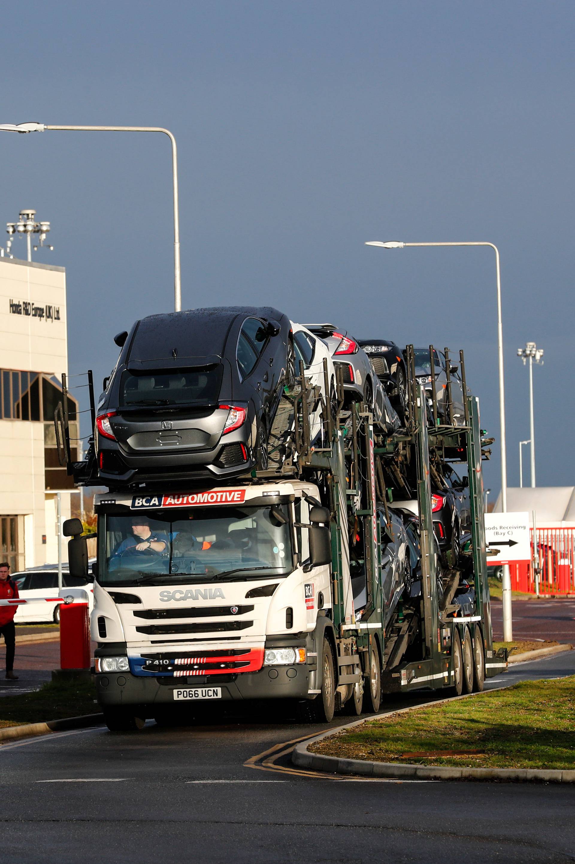 A lorry with car carrier trailer leaves the Honda car plant in Swindon